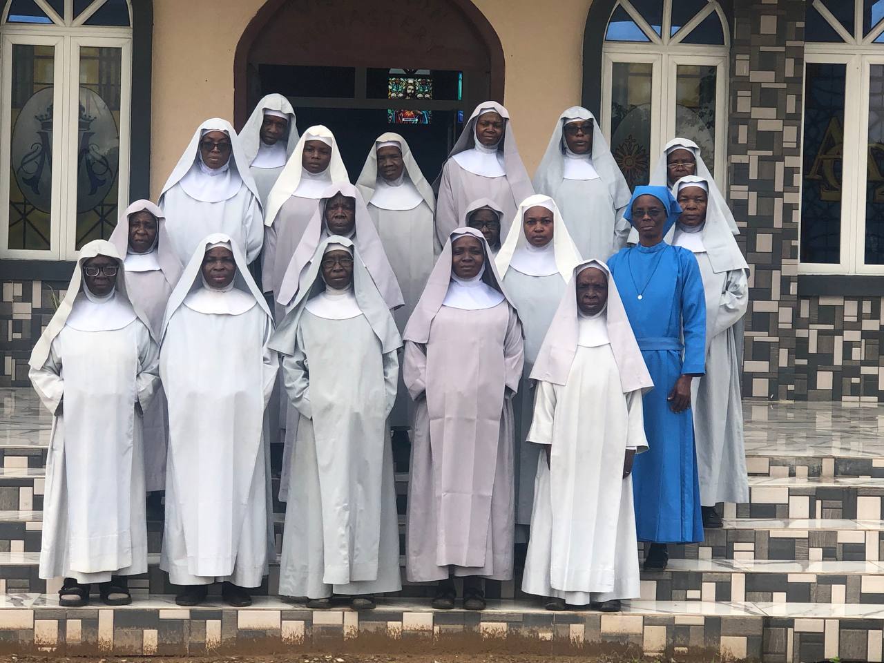 Group Portrait of Devoted Catholic Sisters in Front of a Beautiful Church